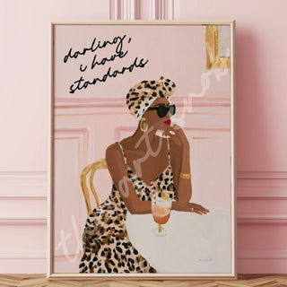 Black woman in a leopard print dress and matching headwrap, wearing sunglasses at a table beneath the words “Darling, I have standards.”